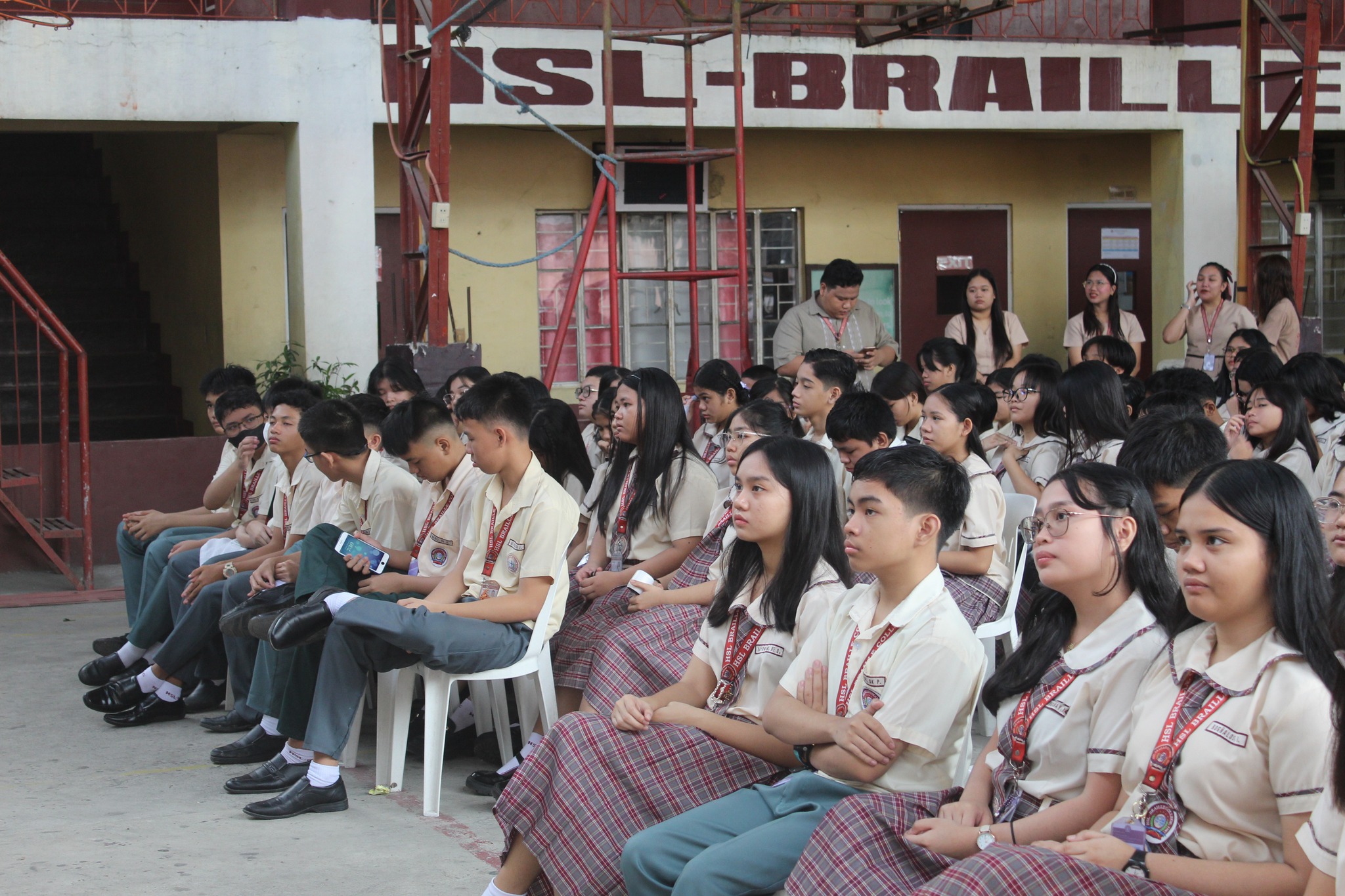 High school students sitting in a large hall