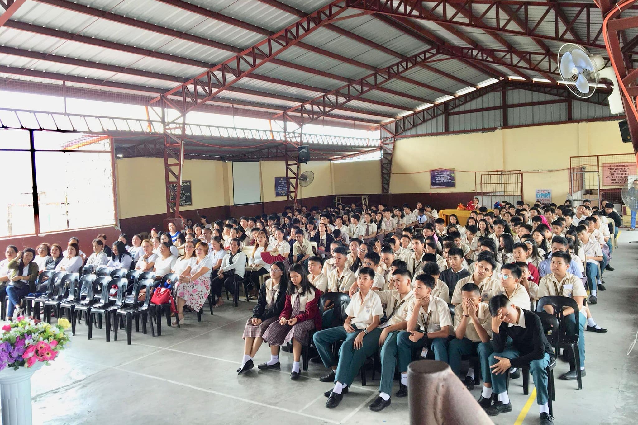 Senior High students sitting in a school courtyard